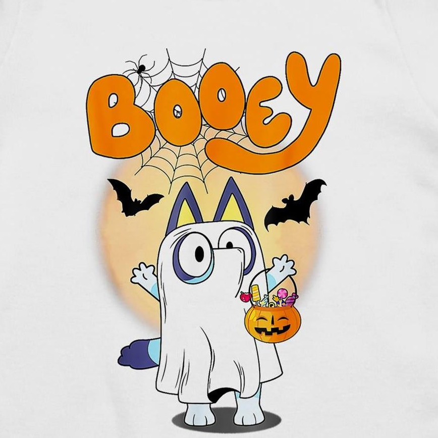 A white t-shirt featuring a colorful cartoon graphic of a ghost character dressed as Bluey, holding a jack-o'-lantern bucket of candy, with the word 'Booey' in orange above.