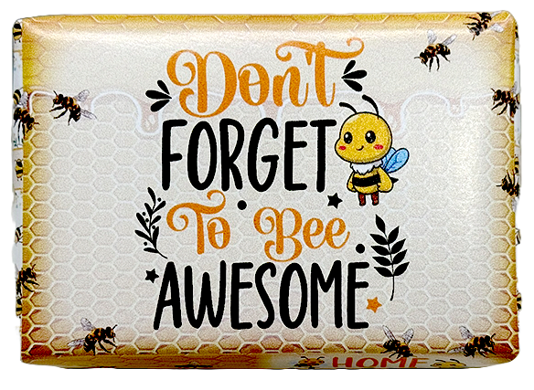 A packaged decorative item with the phrase “Don’t Forget to Bee Awesome” in orange and black lettering on a honeycomb-style background, plus a cartoon bee and bees around the border.