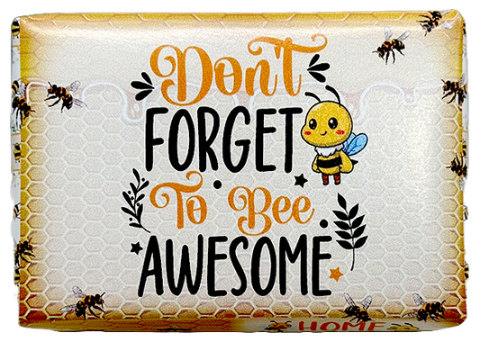 A packaged decorative item with the phrase “Don’t Forget to Bee Awesome” in orange and black lettering on a honeycomb-style background, plus a cartoon bee and bees around the border.