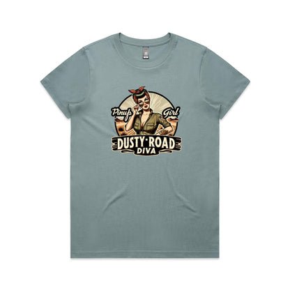 A graphic print on a white background featuring a retro-style pinup illustration of a woman with sunglasses, a red bandana, and an olive green shirt, with the text 'Pinup Girl' and 'Dusty Road Diva'.