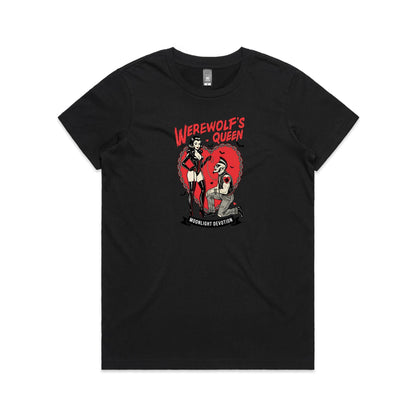 A black graphic t-shirt featuring a stylized illustration of a woman in a red corset and thigh-high boots standing in front of a red heart with a chain, next to a kneeling man with a mohawk. The text reads 'WEREWOLF'S QUEEN' at the top and 'MOONLIGHT DEVOTION' on a banner at the bottom.