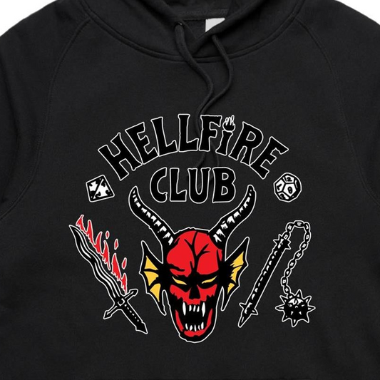 Close-up of a black hoodie featuring a graphic print with the words 'HELLFIRE CLUB' and a red horned skull surrounded by a sword, flame motif, chain, and skull emblem.