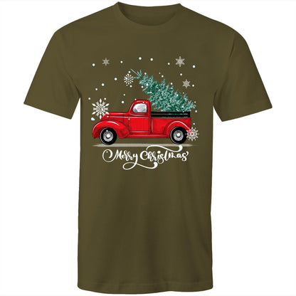 A green crewneck t-shirt featuring a festive graphic of a vintage red pickup truck carrying a Christmas tree, surrounded by white snowflakes and the text 'Merry Christmas' in white script.
