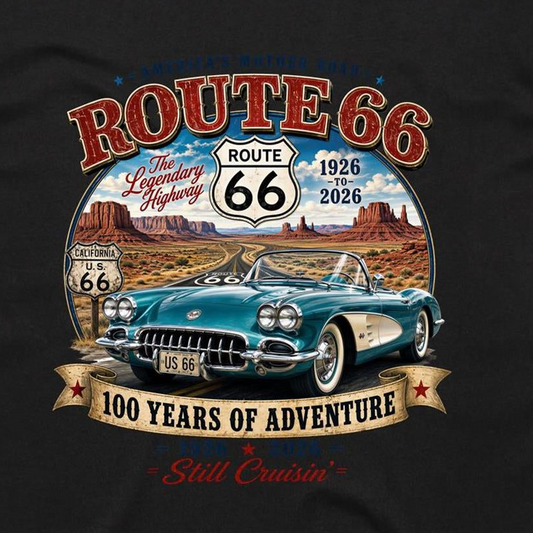 A black graphic t-shirt featuring a vintage-style Route 66 design. The print shows a teal classic Corvette car, desert canyons, and retro Route 66 signs with text reading 'ROUTE 66', 'The Legendary Highway', '1926 to 2026', '100 YEARS OF ADVENTURE', and 'Still Cruisin''.