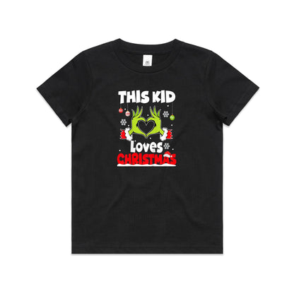 A close-up of a green Christmas t-shirt featuring a graphic of the Grinch's hands forming a heart, with the text 'THIS KID Loves CHRISTMAS' in white and red.