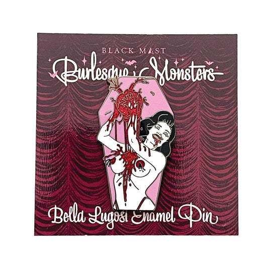 A Black Mast 'Burlesque Monsters' enamel pin of 'Bella Lugosi', shown on its illustrated backing card. The pin depicts a woman in a coffin-shaped casket with a bloody severed heart.