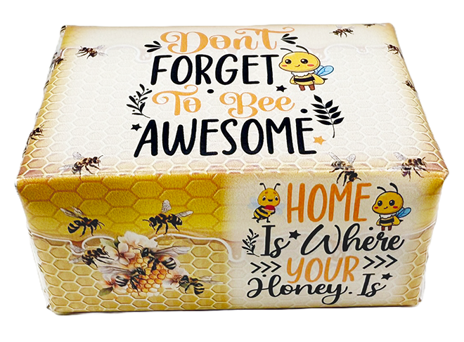 A rectangular decorative box with a honeycomb pattern and cartoon bees, printed with the phrases “Don't Forget To Bee Awesome” and “Home Is Where Your Honey Is.” on a white background.