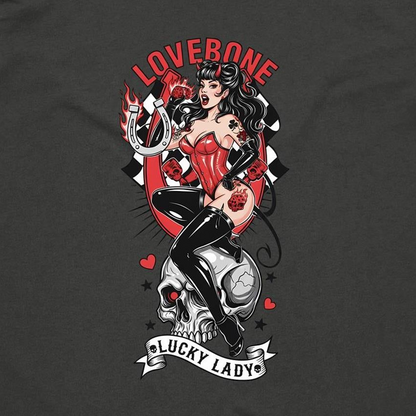 A dark charcoal gray t-shirt featuring a large graphic print of a pin-up style woman with the text 'LOVEBONE' above and a banner reading 'LUCKY LADY' below.