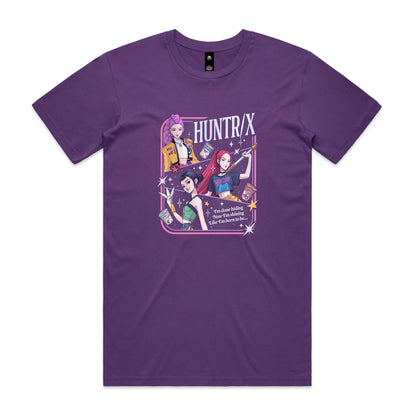 A close-up of a graphic t-shirt featuring three illustrated anime-style female characters with colorful hair and outfits, surrounded by stars and the text 'HUNTR/X'.