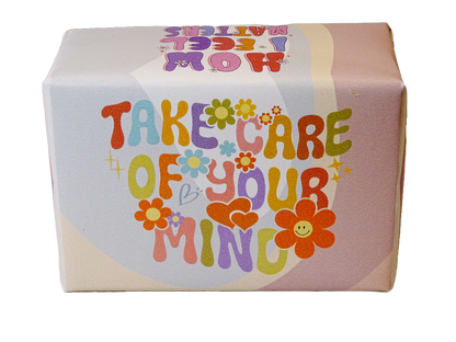 A square product box with a retro 1960s-style design featuring the text 'TAKE CARE OF YOUR MIND' in colorful retro letters with flowers and hearts, on a white background.