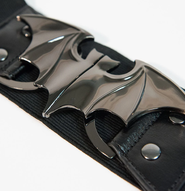 Black belt with metallic bat emblem on a white background