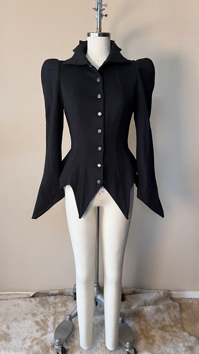 Black jacket on a mannequin against a beige wall