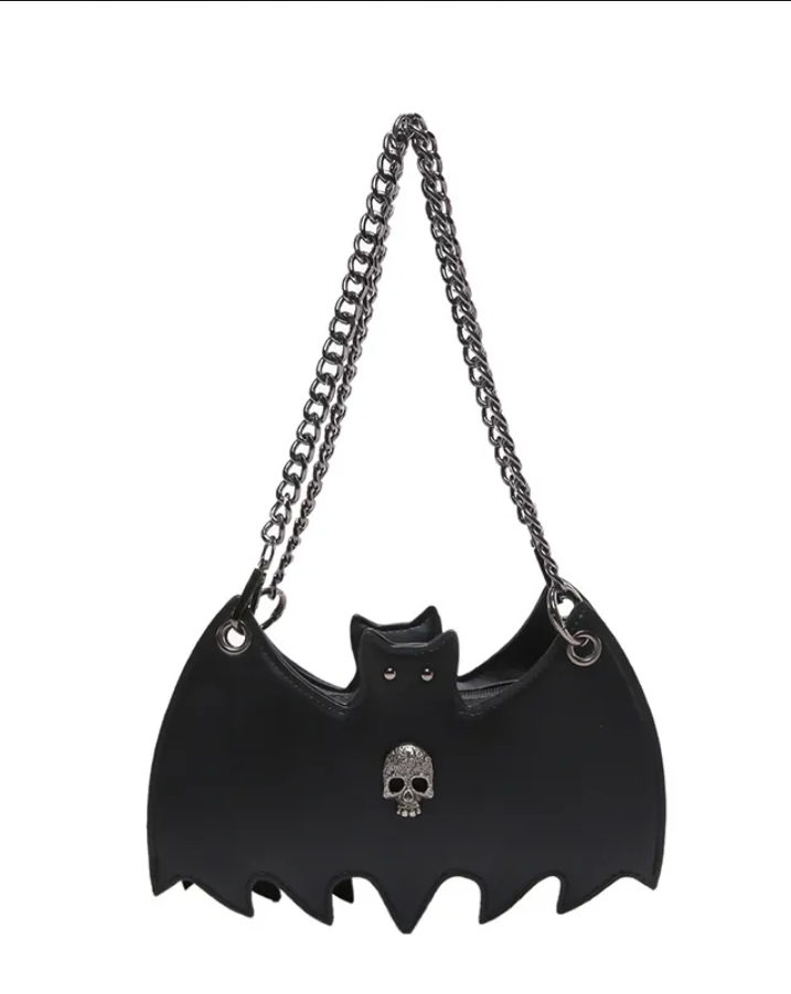 Black faux-leather bat-shaped shoulder bag with a silver-tone chain strap and a small silver skull detail on the front, shown against a plain white background.