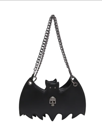 Black faux-leather bat-shaped shoulder bag with a silver-tone chain strap and a small silver skull detail on the front, shown against a plain white background.