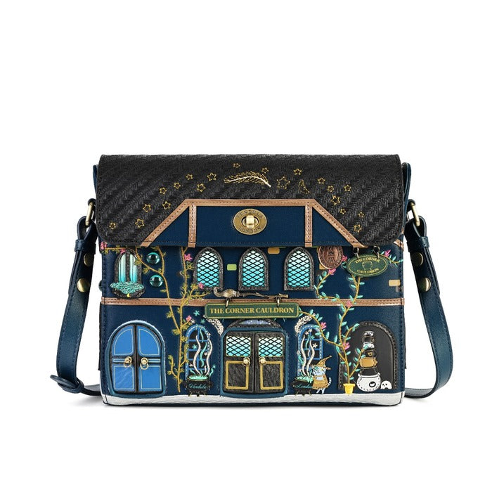 A dark blue and black crossbody bag designed to look like a whimsical house facade, featuring embroidered details, gold accents, and a matching shoulder strap on a white background.