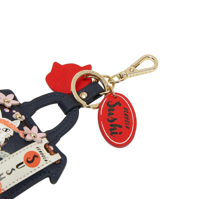 Keychain with red tag and gold clasp on a white background