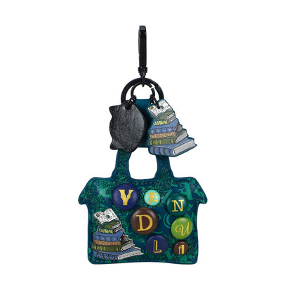 Colorful handbag-shaped keychain with books and letters on a white background