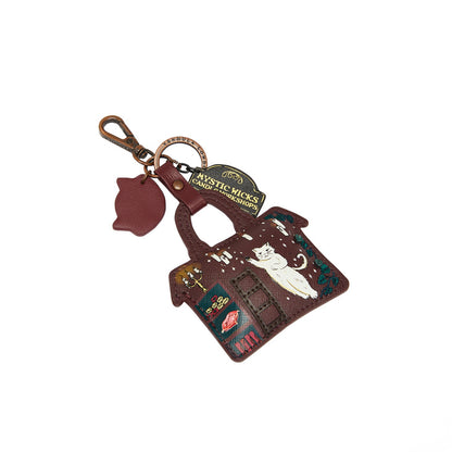 Keychain with cat design and 'Mystic Kicks' branding on a white background