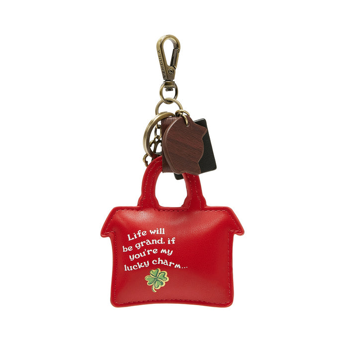 Red purse-shaped keychain with a quote and clover charm on a white background