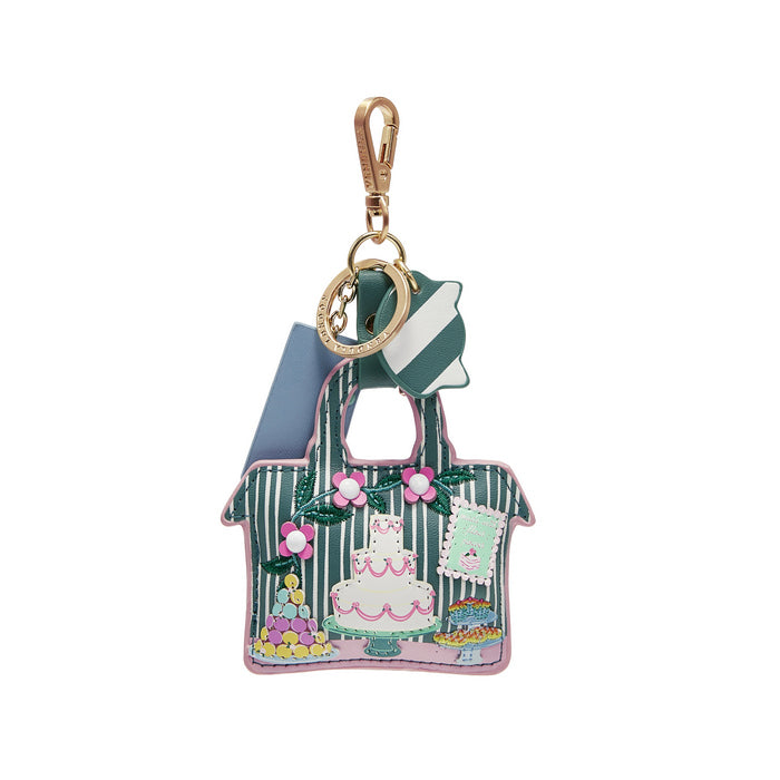 Keychain shaped like a handbag with a cake design on a white background