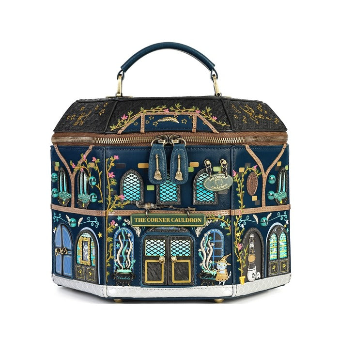 A hexagonal handbag designed to look like the 'The Corner Cabbidon' building from Harry Potter, featuring a dark navy blue base with intricate gold, green, and blue floral and architectural illustrations, topped with a dark blue handle.