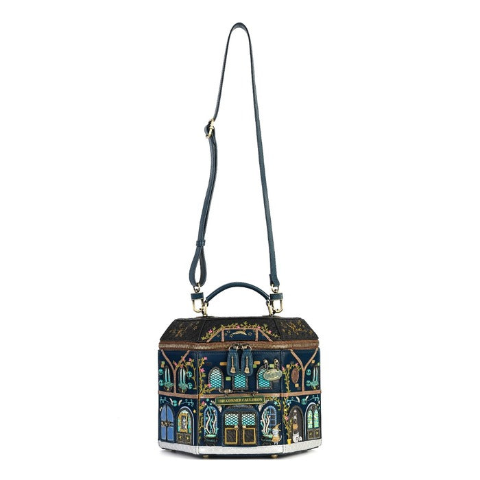 A hexagonal handbag with a dark navy blue base and an intricate multicolor architectural illustration featuring gold, green, and light blue details. It has a dark navy blue shoulder strap and top handle with gold-tone hardware, shown against a plain white background.