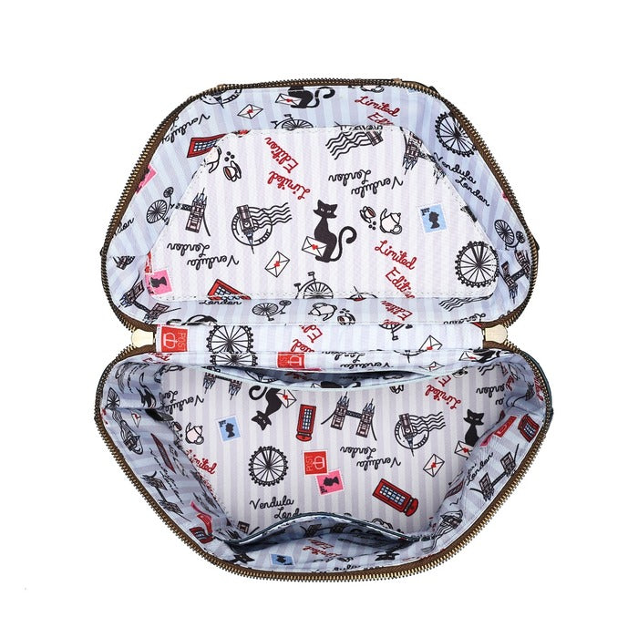 An open zippered cosmetic bag or organizer shown from the inside, featuring a white lining with a vintage-style print of black cats, red envelopes, and London-themed motifs like red buses and postcodes.