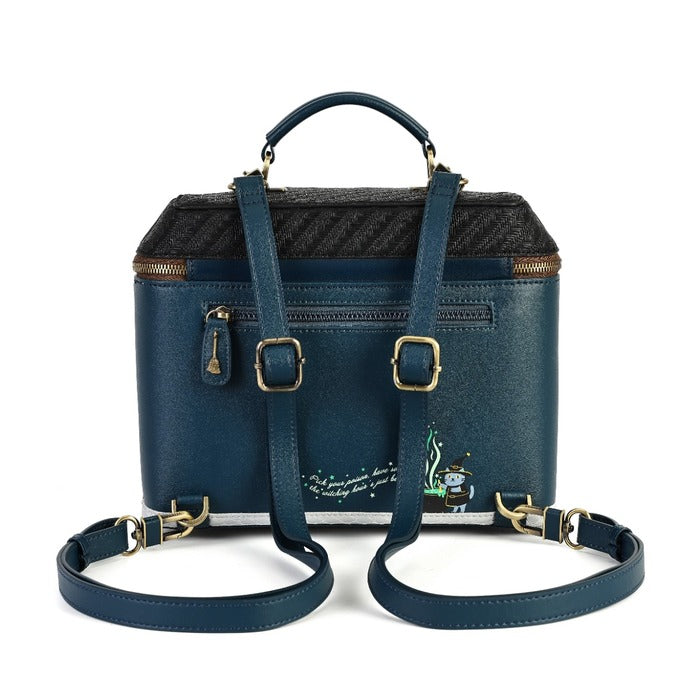 A navy blue leather handbag with a textured black and gray patterned top, gold-tone hardware, a top handle, and a detachable shoulder strap, shown on a white background.