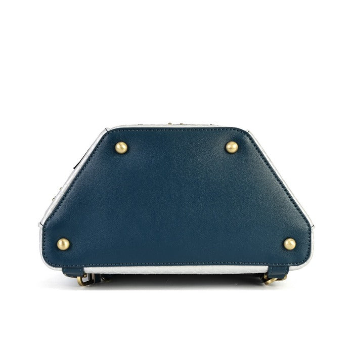 A hexagonal handbag with a dark navy blue base and an intricate multicolor architectural illustration featuring gold, green, and light blue details. It has a dark navy blue shoulder strap and top handle with gold-tone hardware, shown against a plain white background.