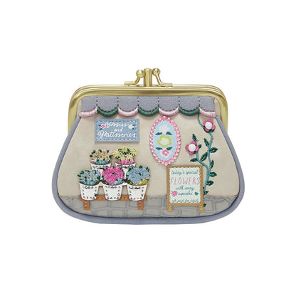 Decorative clutch bag with floral and garden-themed design on a white background