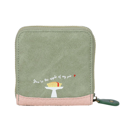 Green wallet with pink bottom section featuring an embroidered design and text on a white background