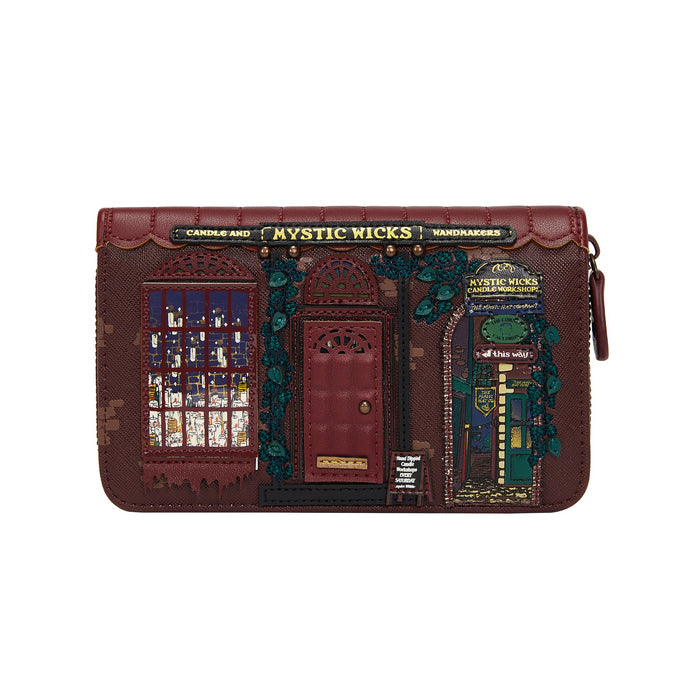 Brown leather wallet with decorative elements and 'Mystic Wicks' branding on a white background