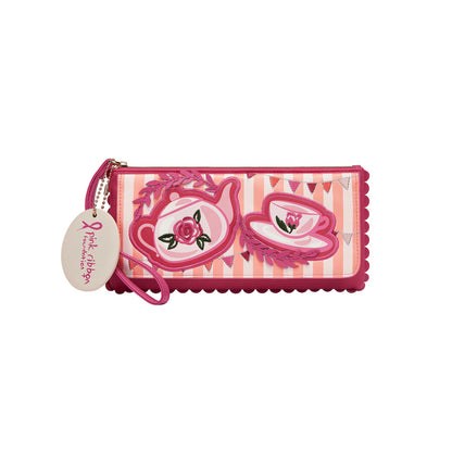 Pink wallet with tea cup design and tag on a white background