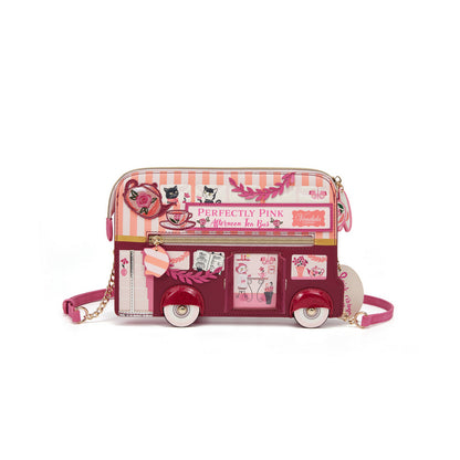 Pink bus-shaped handbag with decorative elements on a white background