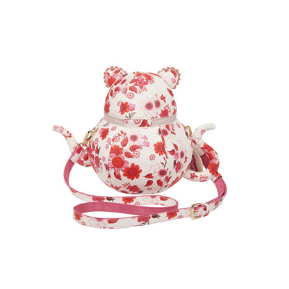 Floral-patterned teapot-shaped bag with a leash on a white background
