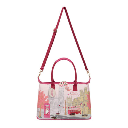 Pink handbag with cityscape design on a white background