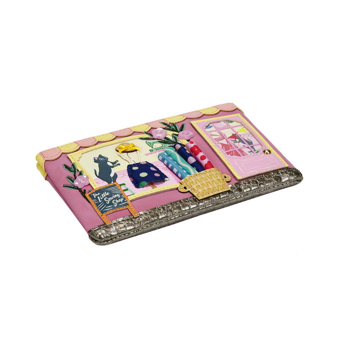 Decorative clutch with cartoon-style clothing display on a white background
