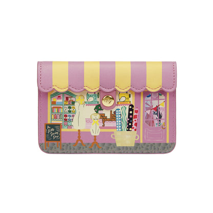 Pink and yellow wallet with a printed design on a white background
