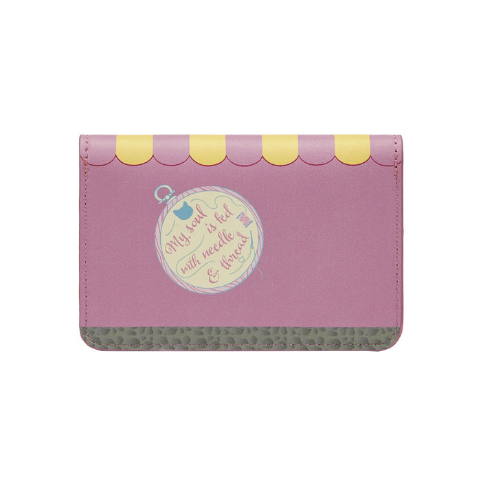 Pink wallet with decorative elements on a white background