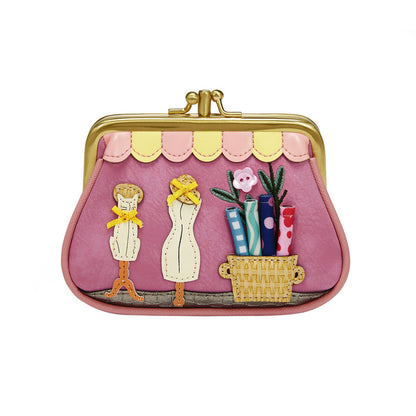 Pink purse with decorative elements on a white background