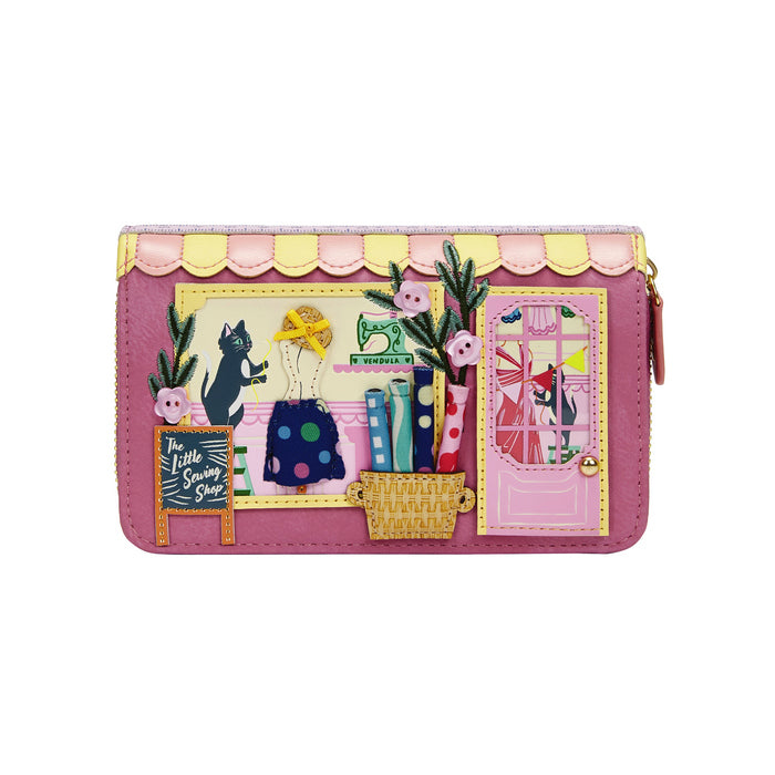 Pink wallet with a decorative design of a sewing-themed scene on a white background