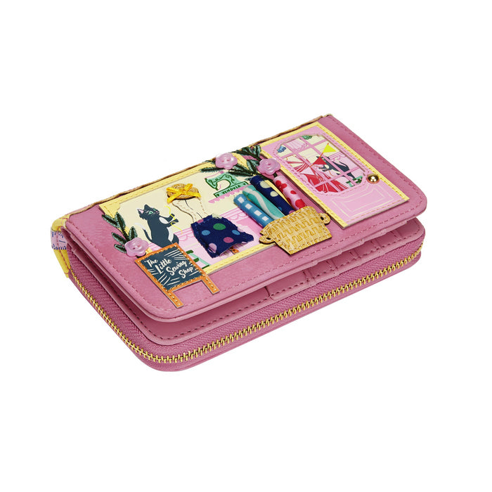 Pink wallet with colorful designs on a white background
