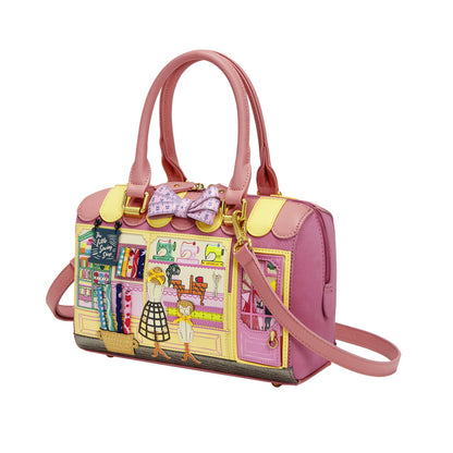 Pink handbag with colorful design on a white background