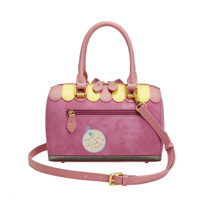 Pink handbag with gold accents on a white background