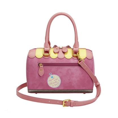 Pink handbag with gold accents on a white background