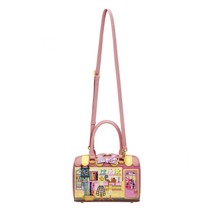 Pink handbag with a colorful design on a white background