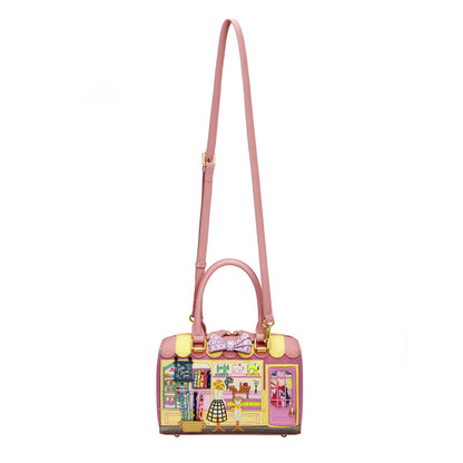 Pink handbag with a colorful design on a white background