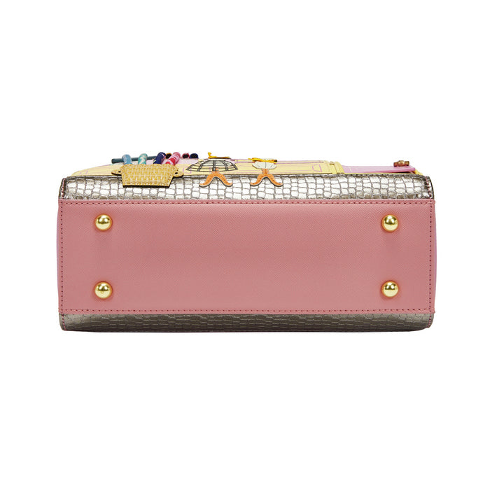 Pink wallet with decorative accents on a white background