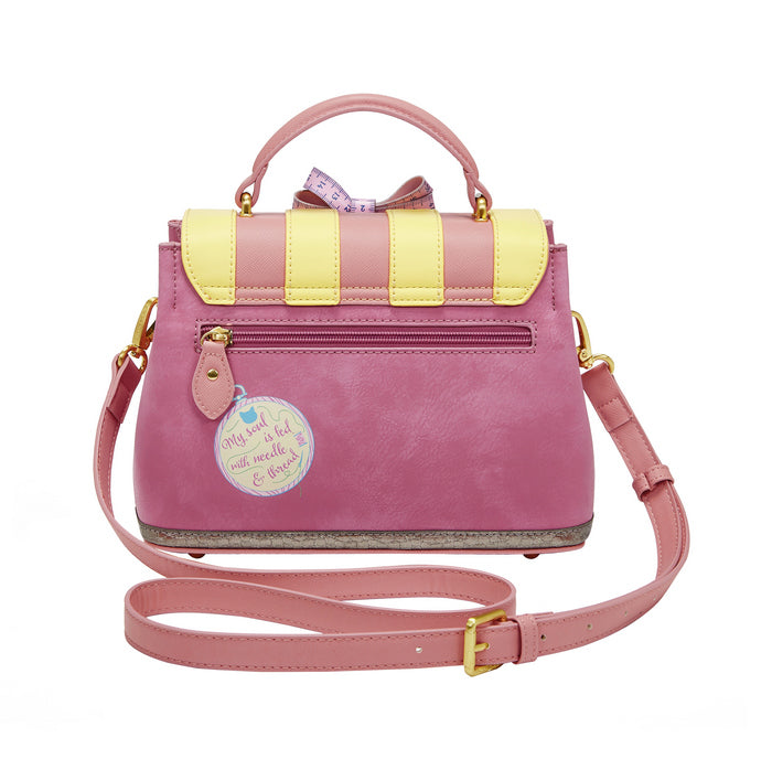 Pink and yellow handbag with a strap on a white background