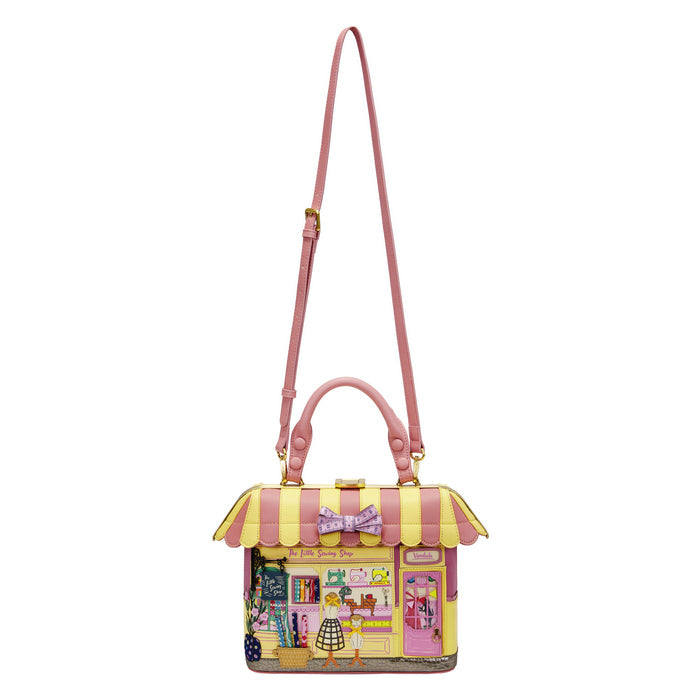 Pink and yellow handbag with a cartoon design on a white background